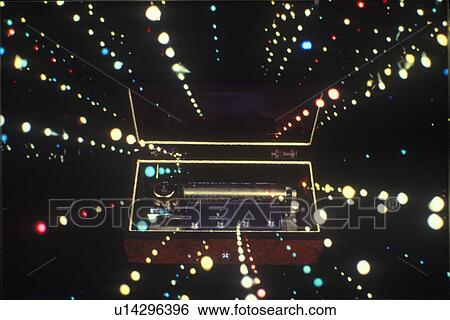 Stock Photograph - Space special effects composite of converging star streams and antique music box. Fotosearch