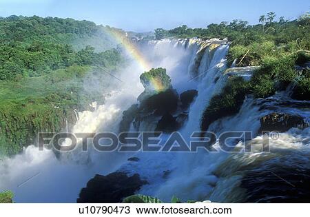 Stock Image - Rainbow over Iguazu Waterfalls. Fotosearch