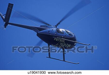 A helicopter in the blue sky View Large Photo Image Stock Image - A helicopter in the blue sky. Fotosearch