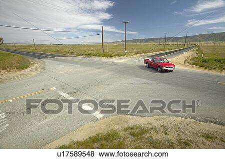 A red truck at a four way intersection View Large Photo Image Stock Photo - A red truck at a four way intersection. Fotosearch
