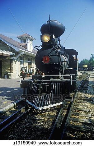 Stock Photo - A steam engine at a train station. Fotosearch