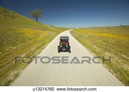 Model T driving down a scenic road View Large Photo Image Stock Image - Model T driving down a scenic road. Fotosearch