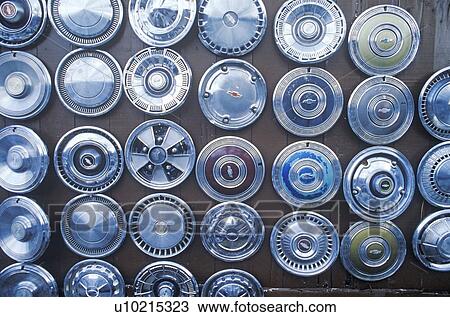 Stock Image - Hubcaps on the wall. Fotosearch