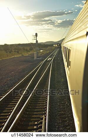 Passenger train travelling into the sunset View Large Photo Image Picture - Passenger train travelling into the sunset. Fotosearch