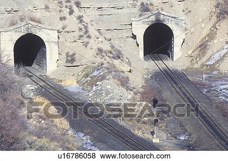Stock Photo - Two train tracks and two tunnels. Fotosearch