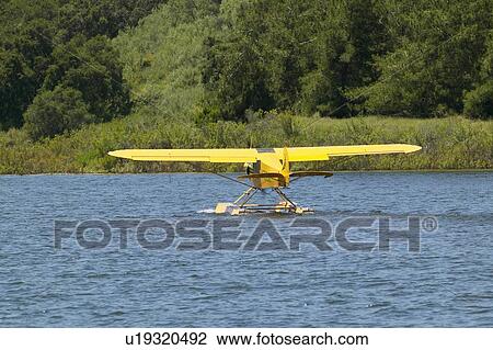 Yellow amphibious seaplane taking off from Lake View Large Photo Image Stock Image - Yellow amphibious seaplane taking off from Lake. Fotosearch