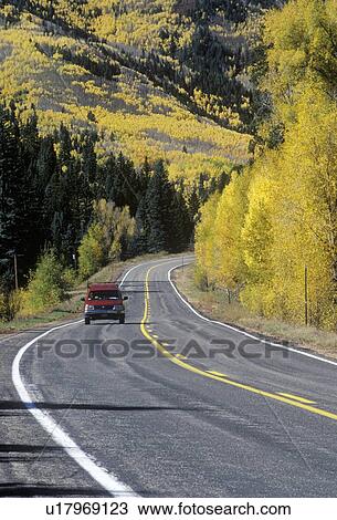 Stock Image - A truck traveling in autumn. Fotosearch