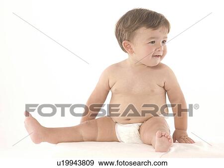 Baby boy sitting on the floor and looking sideways View Large Photo Image Stock Photo - Baby boy sitting on the floor and looking sideways. Fotosearch