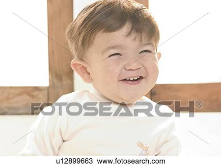 Stock Image - Close-up of a baby boy laughing. Fotosearch
