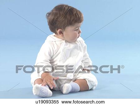 Stock Photography - Close-up of a baby boy sitting on the floor. Fotosearch