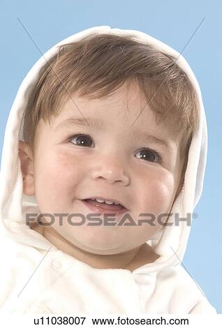 Stock Photo - Close-up of a baby boy wearing a hooded shirt. Fotosearch