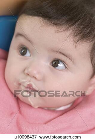 Close-up of a baby girl eating View Large Photo Image Stock Photo - Close-up of a baby girl eating. Fotosearch