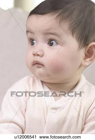 Close-up of a baby girl looking sideways View Large Photo Image Stock Image - Close-up of a baby girl looking sideways. Fotosearch