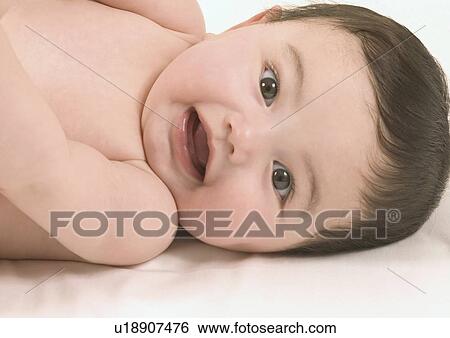 Stock Photograph - Close-up of a baby girl lying down. Fotosearch