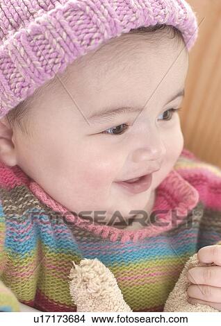 Close-up of a baby girl sitting in a high chair View Large Photo Image Picture - Close-up of a baby girl sitting in a high chair. Fotosearch