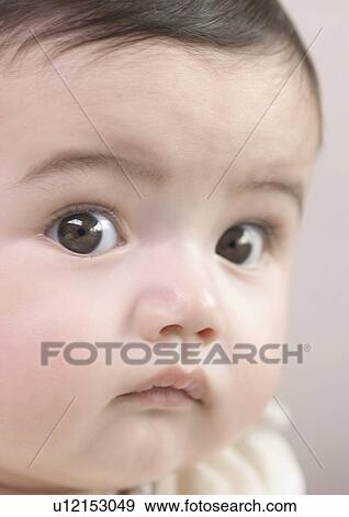 Close-up of a baby girl's face View Large Photo Image Stock Photo - Close-up of a baby girl's face. Fotosearch