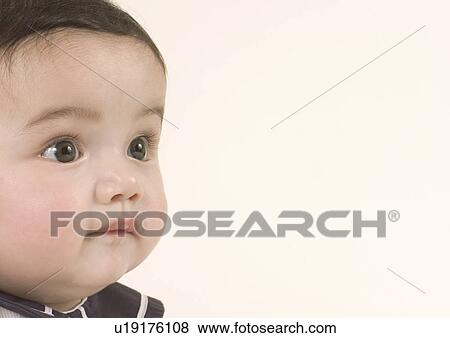 Close-up of a baby girl's face View Large Photo Image Stock Photo - Close-up of a baby girl's face. Fotosearch