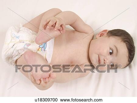 High angle view of a baby girl lying down View Large Photo Image Stock Image - High angle view of a baby girl lying down. Fotosearch