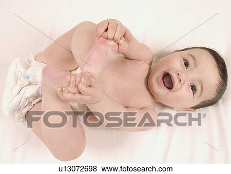 High angle view of a baby girl lying down View Large Photo Image Stock Photo - High angle view of a baby girl lying down. Fotosearch