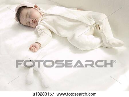 High angle view of a baby girl sleeping View Large Photo Image Stock Photo - High angle view of a baby girl sleeping. Fotosearch