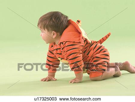 Stock Image - Side profile of a baby boy crawling. Fotosearch