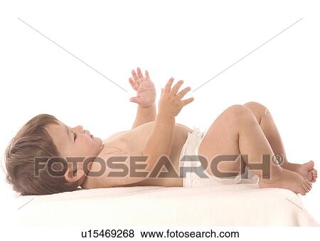 Side profile of a baby boy lying on his back View Large Photo Image Stock Photo - Side profile of a baby boy lying on his back. Fotosearch