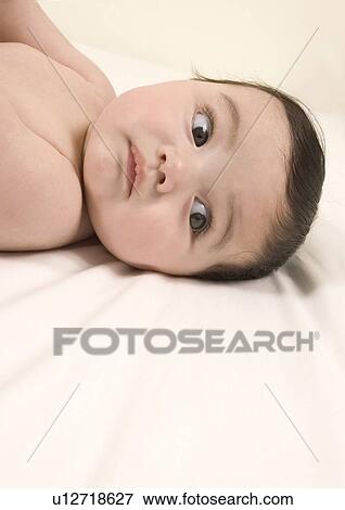 Side profile of a baby girl lying on her back View Large Photo Image Stock Photo - Side profile of a baby girl lying on her back. Fotosearch