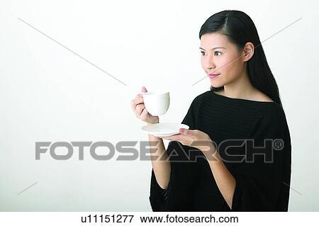 Stock Photo - Close-Up, Beverage, Casual Clothing, Black Hair, Black, Asian Ethnicity. Fotosearch