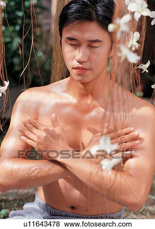 Stock Photo - beauty spa male, process, petals, health and beauty, asian ethnicity. Fotosearch