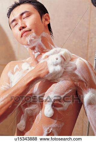 Stock Photo - body care, washing, young adult, close-up, soap suds. Fotosearch
