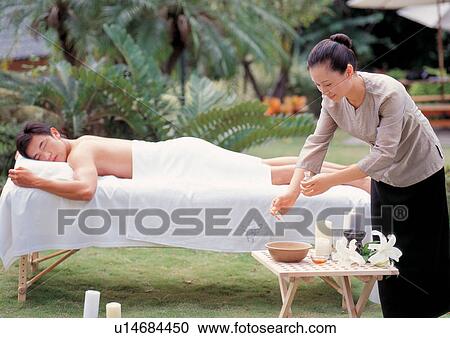 Stock Image - bottle, body spa, close-up, young adult, beauty spa male, beauty treatment. Fotosearch