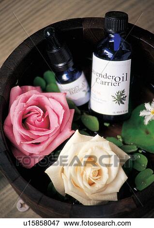 Stock Photo - liquid, wooden surface, blossoms, blooms. Fotosearch