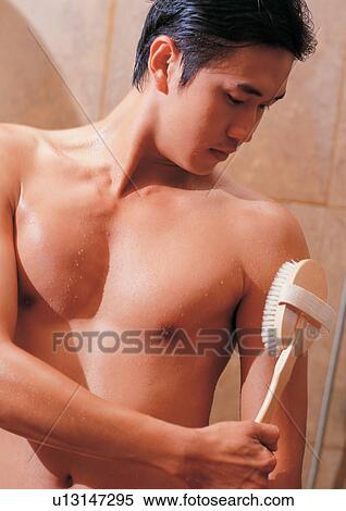 Stock Photography - Man in a shower with a brush . Fotosearch