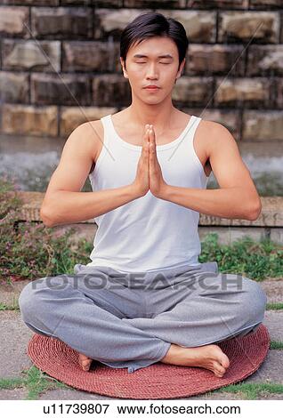 Stock Photo - Man meditating . Fotosearch
