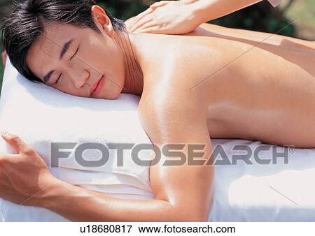 Stock Photo - overlay, lying down, health spa, beauty spa male, eyes closed, asian ethnicity. Fotosearch