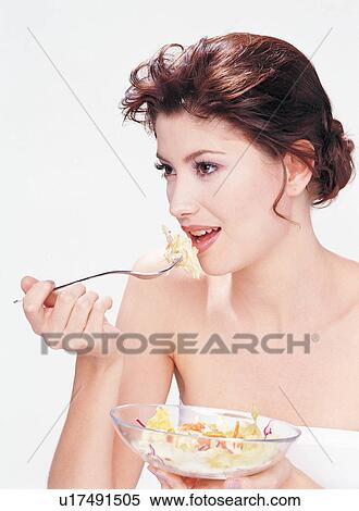 Stock Photography - One Person, Food, Indoor, Human Face, Pampering, Eating. Fotosearch