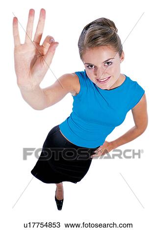 Stock Image - pointing, blonde hair, toothy smile, business attitudes, hand on waist. Fotosearch