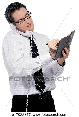 Stock Photo - tie, young adult, business man, telephone receiver, man only, looking down. Fotosearch