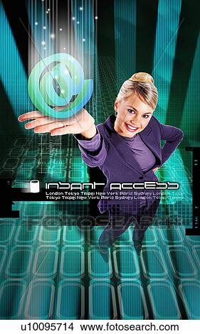 High angle view of a young woman holding an internet symbol View Large Photo Image Picture - High angle view of a young woman holding an internet symbol. Fotosearch