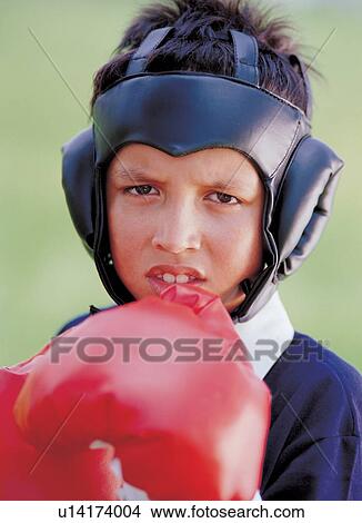 Picture - aggression, boy, boxing helmet, 6-7 years. Fotosearch