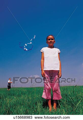 Stock Image - air borne, carefree, bare footed, 6-7 years. Fotosearch