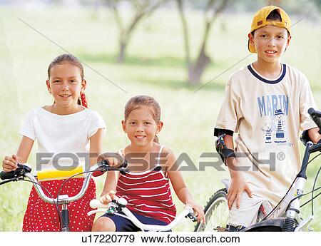 Stock Photo - joy, leisure activity, childhood, grass, expression, youth. Fotosearch