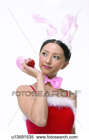 Stock Photography - Close-Up, Asian Ethnicity, Casual Clothing, Bow, Black Hair, Apple. Fotosearch
