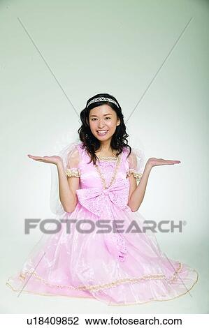 Stock Image - Looking At Camera, Glamour, Spirituality, One Person, Toothy Smile, Artificial Wing, Long Hair. Fotosearch