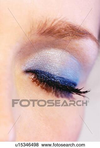 Stock Photo - Blue eye shadow on a closed eye. Fotosearch