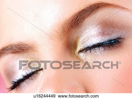 Stock Photo - Eyes with lots of make-up on them. Fotosearch