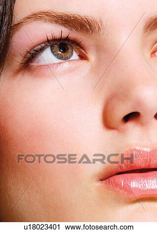 Stock Image - Female looking up with hazel eyes. Fotosearch
