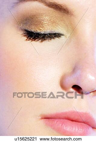 Up close to a closed female eye with gold make-up View Large Photo Image Stock Image - Up close to a closed female eye with gold make-up. Fotosearch