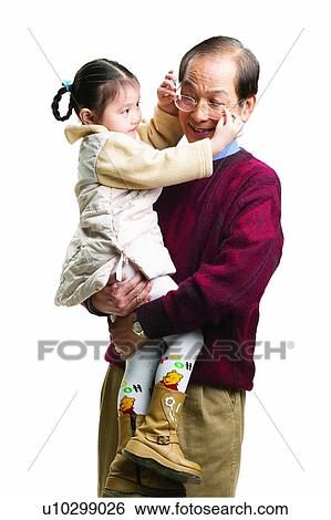 Stock Photograph - Adjusting, Black Hair, Balding, Asian Ethnicity, 6-7 Years. Fotosearch