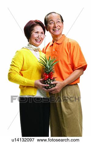 Stock Photo - Brown Hair, Balding, Healthy Eating, Casual Clothing, Asian Ethnicity, Holding. Fotosearch